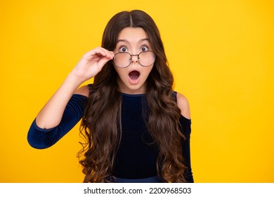 Surprised Teenager Girl. Shocked Amazed Face. Portrait Of Teenager Child In Glasses. Kid At Eye Sight Test. Girl Holding Eyeglasses And Looking At Camera. Eyesight Measurement For School Children.