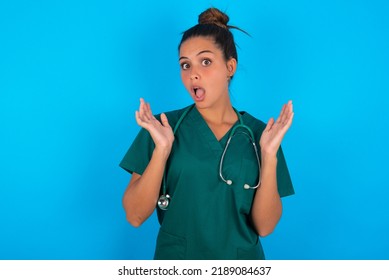 Surprised Terrified Beautiful Doctor Woman Wearing Medical Uniform Over Blue Background Gestures With Uncertainty, Stares At Camera, Puzzled As Doesn't Know Answer On Tricky Question, People,