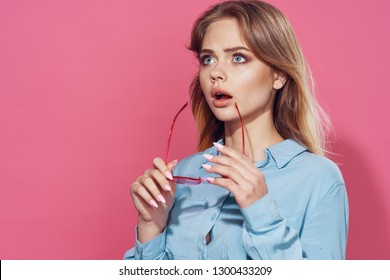 Surprised Woman With Closed Mouth Holds Glasses In Her Hand                      