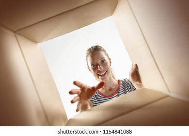 The Surprised Woman Opening Box And Looking Inside. The Package, Delivery, Surprise, Gift, Lifestyle Concept. Human Emotions Concepts