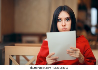 Surprised Woman Reading Legal Documents in a Restaurant. Unhappy person receiving concerning news in the mail
