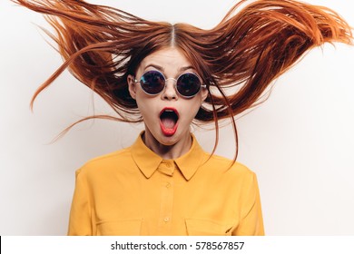 Surprised woman, woman in shock, surprise and flying hair. open-mouthed