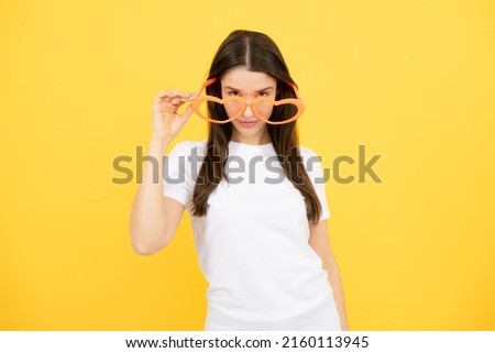 Surprised woman, shocking girl wearing funny glasses on isolated yellow background, Wow face feelings with copy space for advertising.