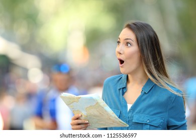 Surprised Woman Sightseeing Looking At Side Holding A Map On The Street