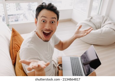 Surprised And Wow Face Of Asian Man Happy With The Result In His Tablet.