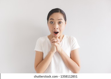 Surprised and wow face expression of Asian woman in white t-shirt. Concept of happy and impressive.