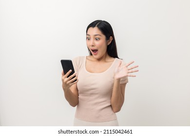Surprised young Asian lady using mobile phone. Very Shocked face asia woman holding smartphone. Looking at cell phone screen. Victory moment. Very enjoy and fun relax time - Shutterstock ID 2115042461