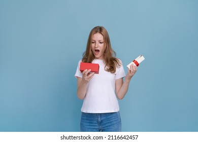 Surprised Young Caucasian Woman Holding Red Gift Box And Shocked With Open Mouth Standing On Blue Background Beautiful Girl Happy Smile Holding Generic Box Suitable For Any Holiday Use For Advertising