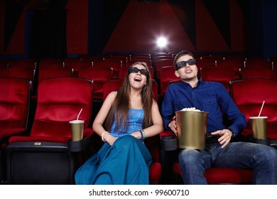 Surprised Young Couple In A Movie Theater