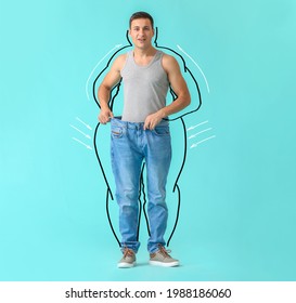 Surprised young man after weight loss on color background - Shutterstock ID 1988186060