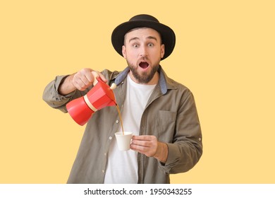 Surprised Young Man With Hot Coffee On Color Background
