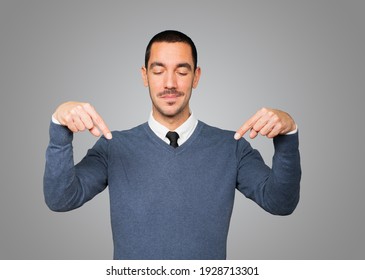 Surprised Young Man Pointing Down