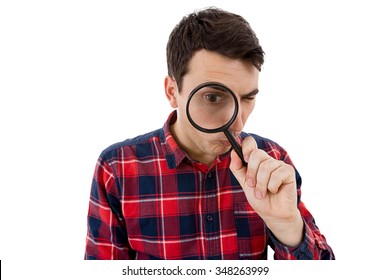 Surprised Young man student holding magnifying glass looking to something isolated over white background.