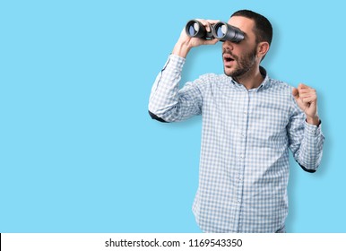 Surprised Young Man Using A Binoculars