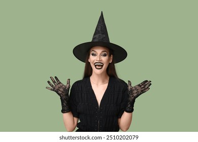 Surprised young woman dressed for Halloween as witch on green background - Powered by Shutterstock