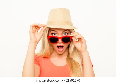 Surprised  young woman in hat and glasses with open mouth
