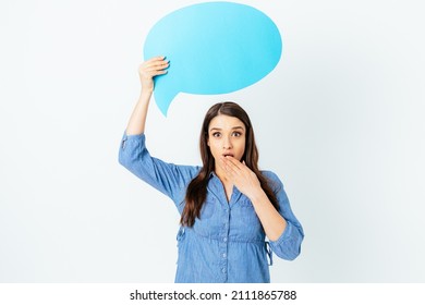 Surprised Young Woman Holding Chat Bubble Above Her Head With Blank Space For Text, Standing On White Studio Background