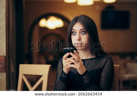 Surprised Young Woman Receiving a Text Message. Lady overreacting after looking at her mobile phone
