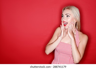 So surprising. Youthful attractive blond-haired woman standing on isolated red background with surprised look. - Shutterstock ID 288741179
