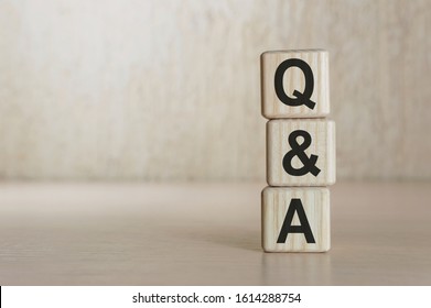Surreal abstract geometric floating wooden cube with vocabulary Q and A on wood floor and white background