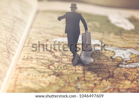 surreal businessman runs over a giant map towards a lucrative job