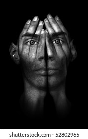 Surreal Dark Portrait Of A Young Man Covering His Face And Eyes With His Hands, But He Can See Right Through Them.