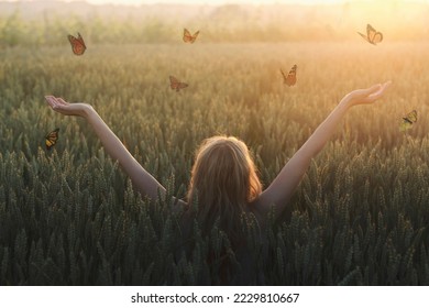 surreal encounter between a woman and free butterflies flying in the middle of nature - Shutterstock ID 2229810667