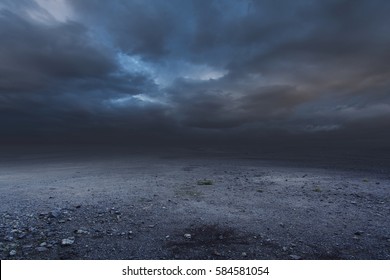 Surreal gravel dark background with dramatic sky - Shutterstock ID 584581054