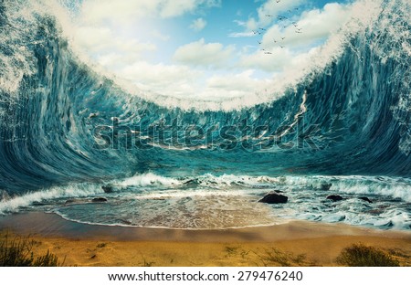 Surreal image of huge waves surrounding dry sand.