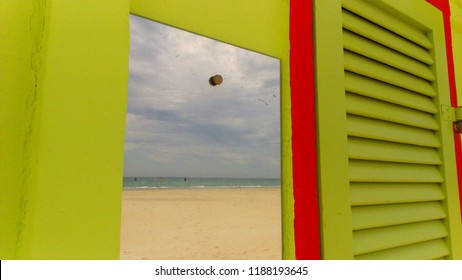 surreal and lonely view of the beach through the mirror of a colorful cabin at Riccione in winter - Shutterstock ID 1188193645