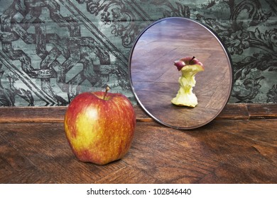 surrealistic picture of an apple reflecting in the mirror