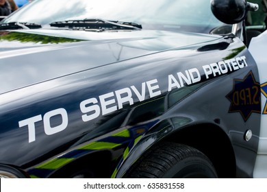 Surrey, UK. 1st May 2017. Close Up Of American Police Car With The Slogan TO SERVE AND PROTECT Along The Side.