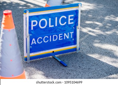 Surrey, UK. 5th May 2018. EDITORIAL - Elevated View Of Blue POLICE ACCIDENT Sign Beside Two Traffic Cones, On A Road In Surrey, UK.
