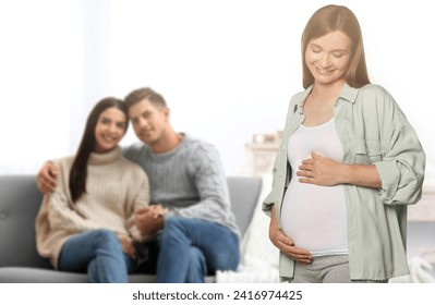 Surrogate mother and intended parents in room - Powered by Shutterstock