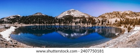 Surrounding mountains reflected in the calm waters of Lake Helen, Lassen Volcanic National Park, Northern California