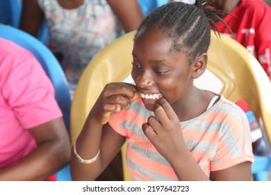 Surulere, Lagos: September 4, 2022-A Young Girl Using Flux To Fix Her Teeth After Eating.