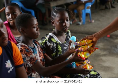 Surulere, Lagos: September 4, 2022-Teenage Girl Receiving Foods From A Community Giveays