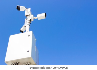 Surveillance camera. Surveillance cameras on sky background. Concept of surveillance and monitoring camera with parking security system concept. Mockup.