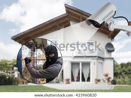 Surveillance Camera Capturing Burglar Using Crowbar To Open Glass Door