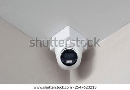 Surveillance camera installed on the corner between ceiling and wall