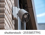 Surveillance camera mounted on a residential wall