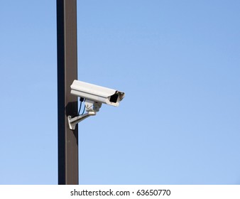 Surveillance Camera On Light Pole In Parking Lot