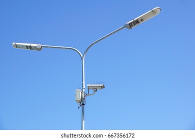 Surveillance Camera On Light Pole In Parking Lot