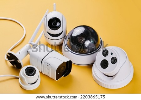 Surveillance cameras, set of different videcam, cctv cameras isolated on yellow background close up. home security system concept
