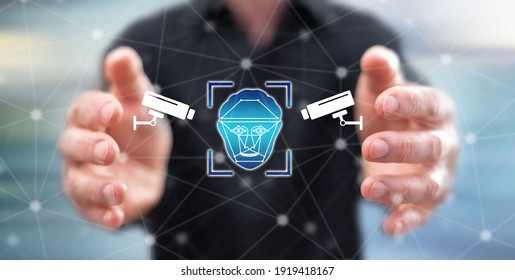 Surveillance system concept between hands of a man in background