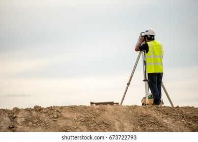 survey engineer in construction site use theodolite mark a concrete pile co ordinate 