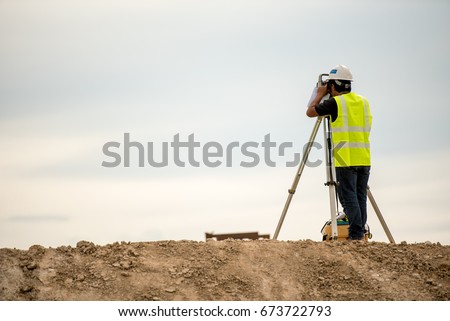 survey engineer in construction site use theodolite mark a concrete pile co ordinate 