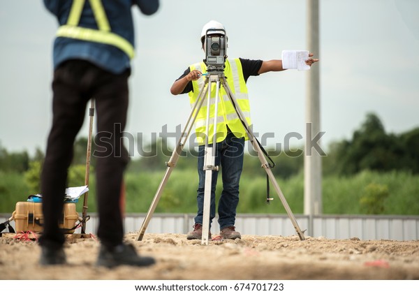 survey engineer in\
construction site use theodolite mark a concrete pile co ordinate\
in construction site