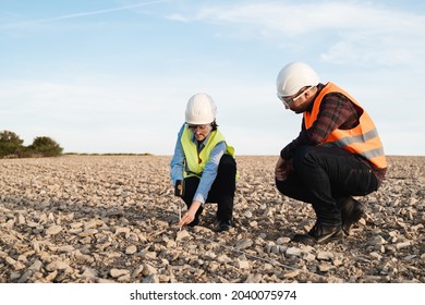 Survey Engineers Working At Construction Land Site - Topographic Work Concept - Focus On Woman Face