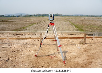 Survey Equipment, A Theodolite At A Construction Site. Geodetic Total Station On Tripods. 